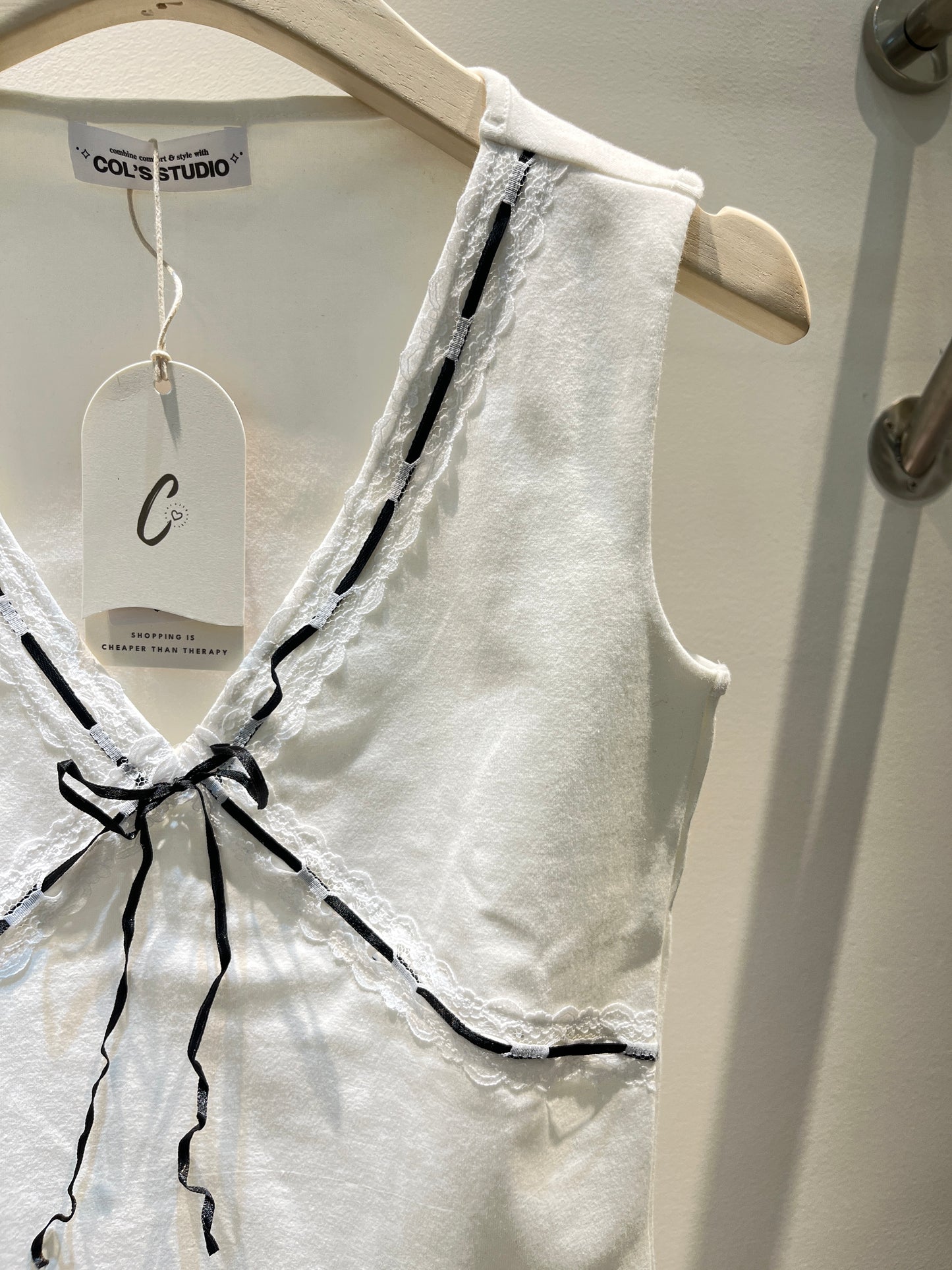 White top with black ribbon