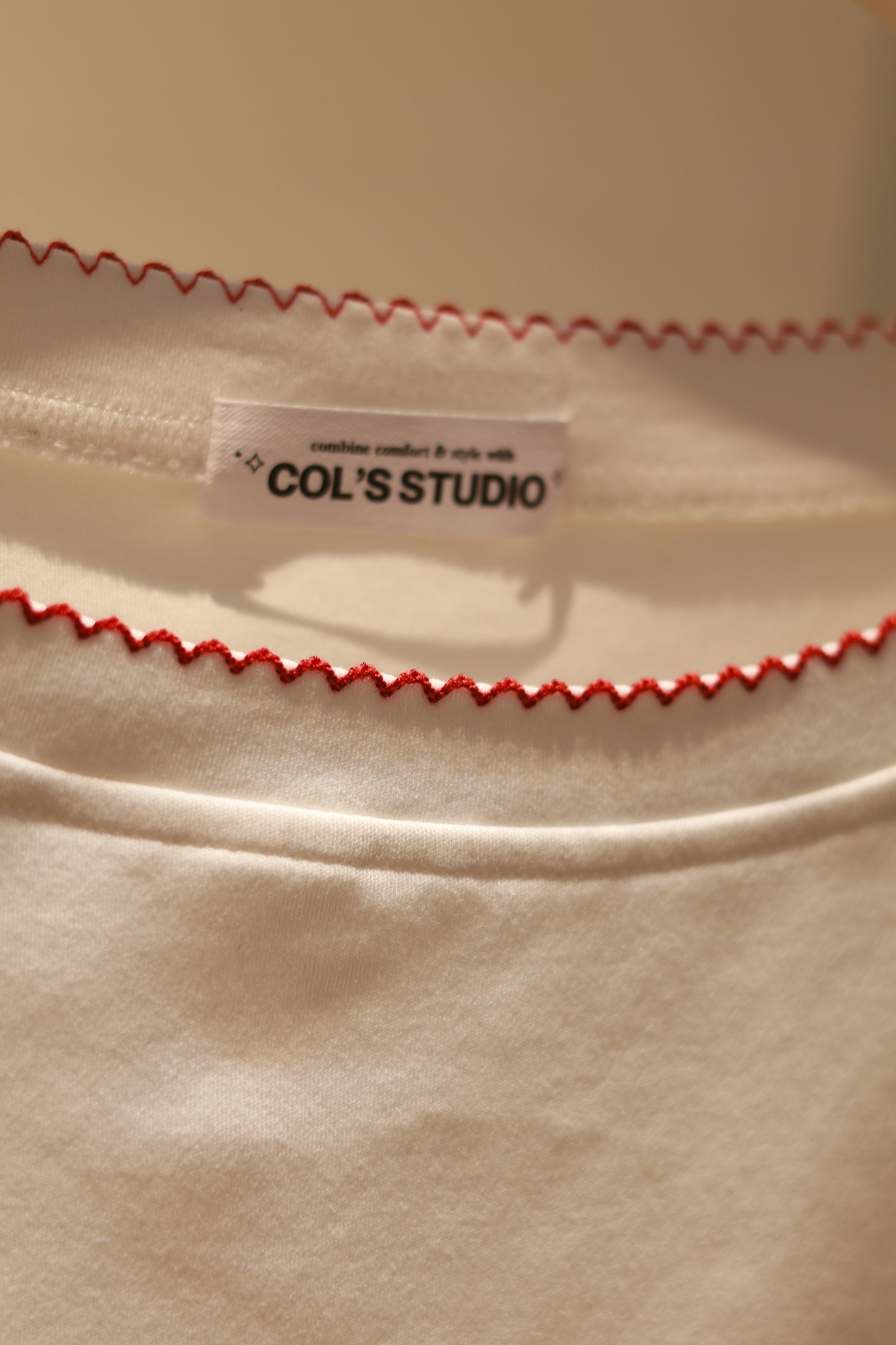 ANGEL GRAPHIC HALF SHOULDER TOP