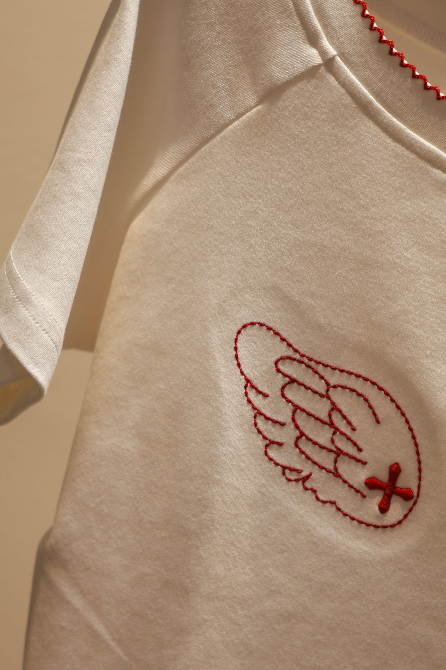 ANGEL GRAPHIC HALF SHOULDER TOP