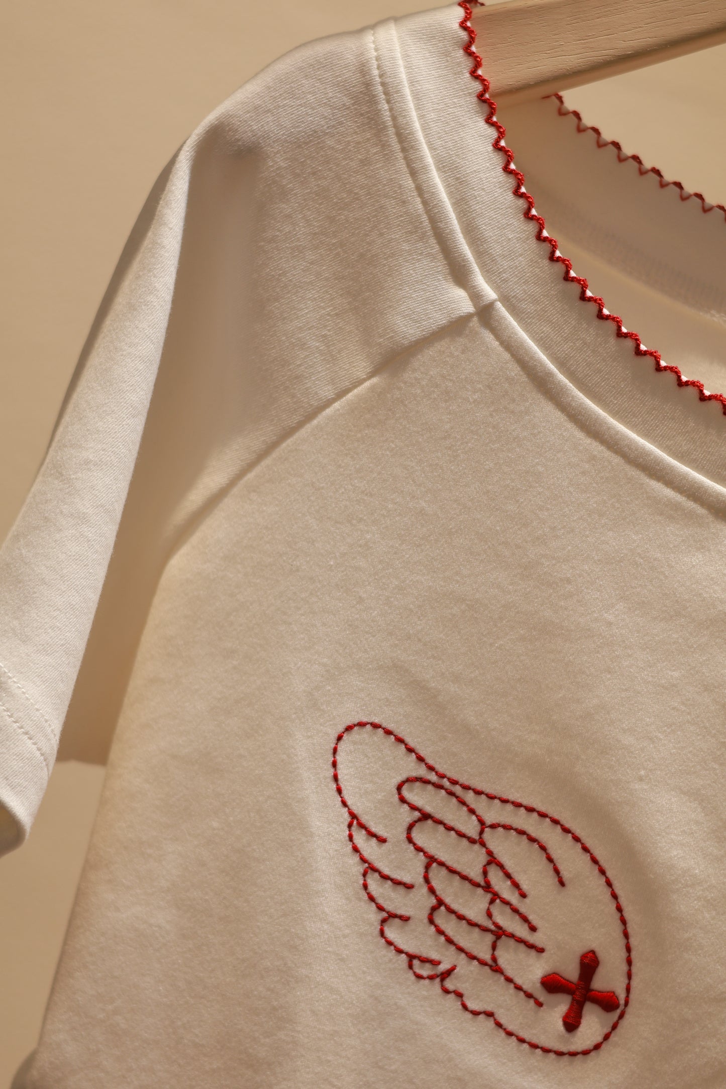 ANGEL GRAPHIC HALF SHOULDER TOP