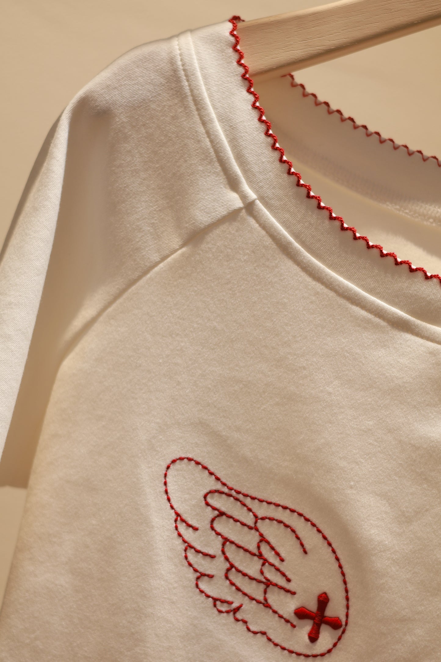 ANGEL GRAPHIC HALF SHOULDER TOP