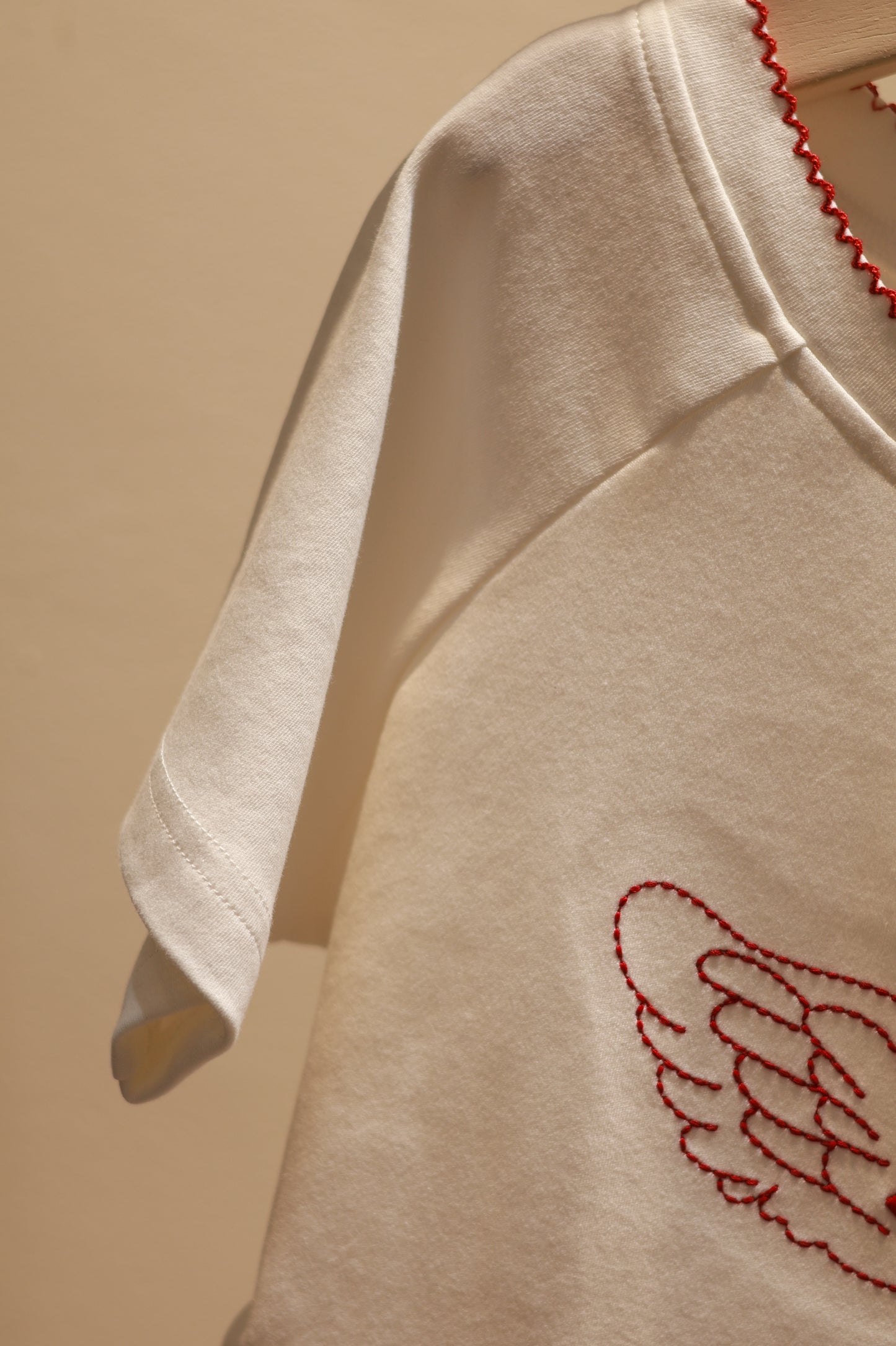 ANGEL GRAPHIC HALF SHOULDER TOP