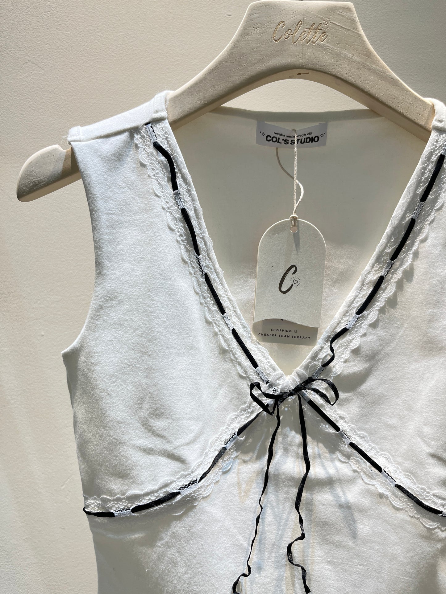 White top with black ribbon
