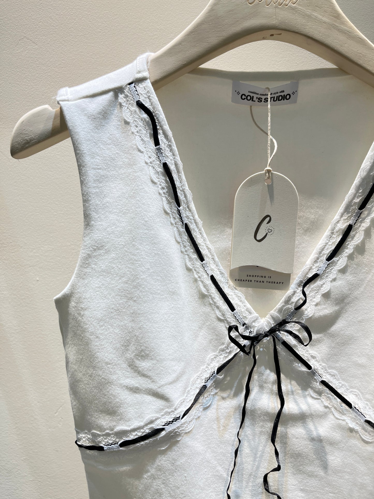 White top with black ribbon