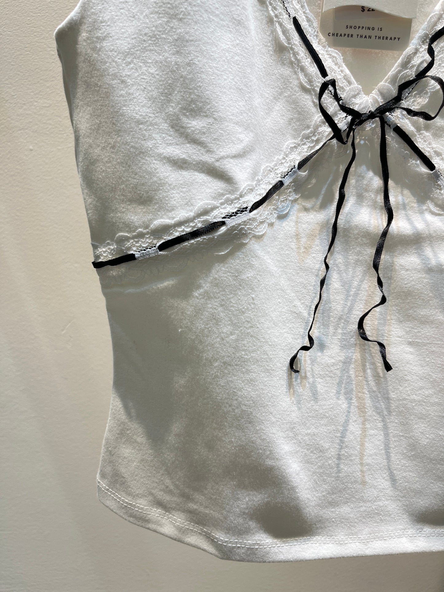 White top with black ribbon