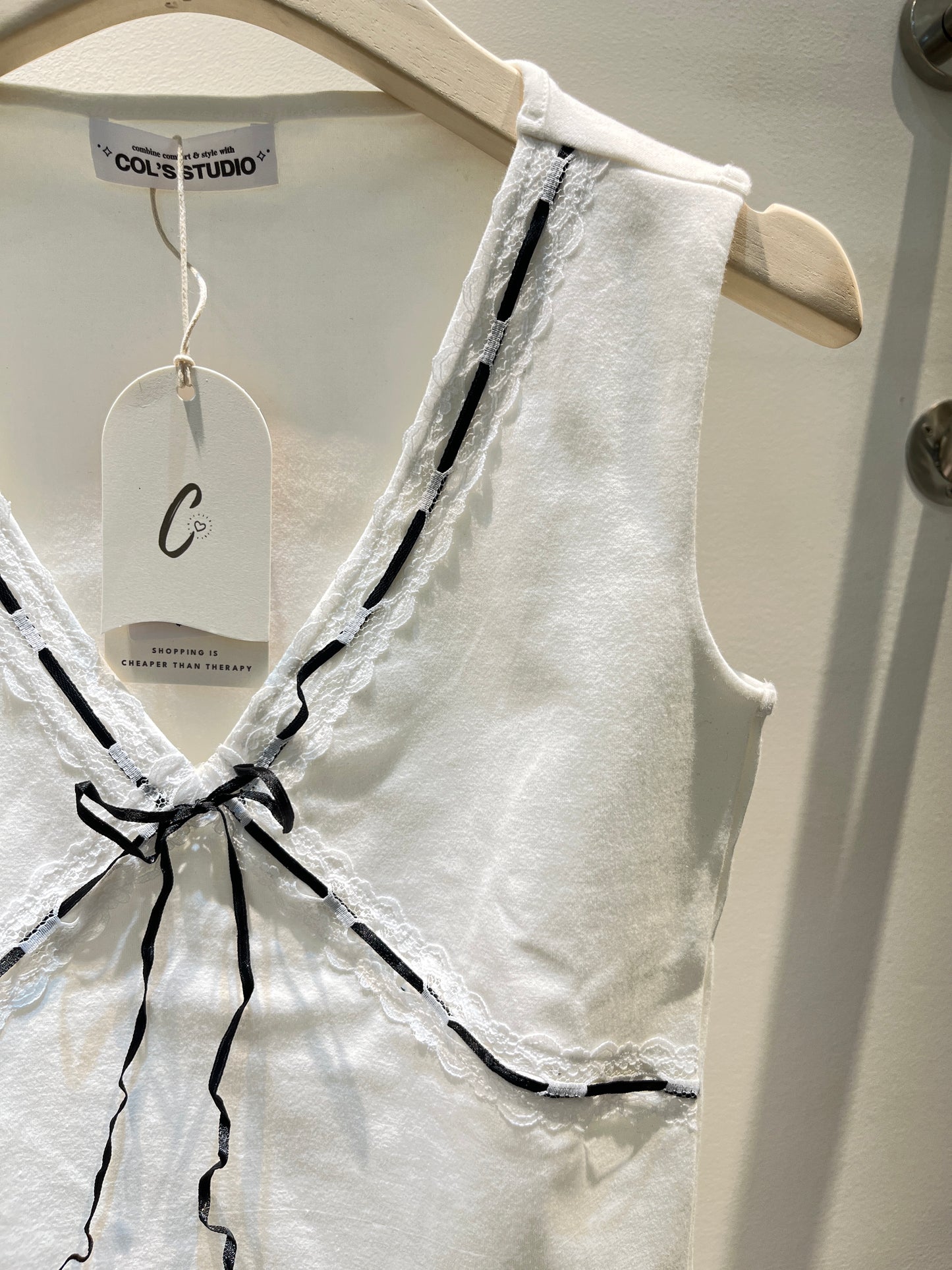 White top with black ribbon