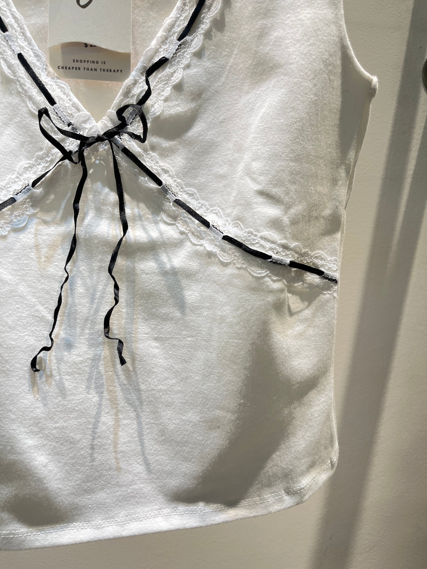 White top with black ribbon